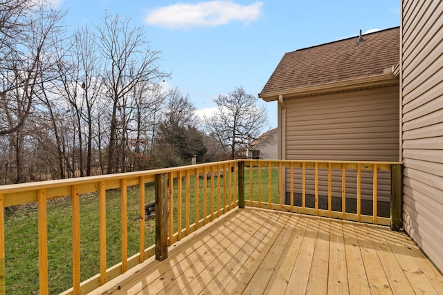 wooden terrace featuring a lawn