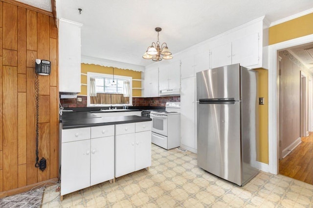 kitchen with electric stove, white cabinetry, and stainless steel refrigerator