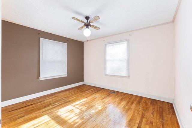 spare room featuring crown molding, ceiling fan, and wood-type flooring