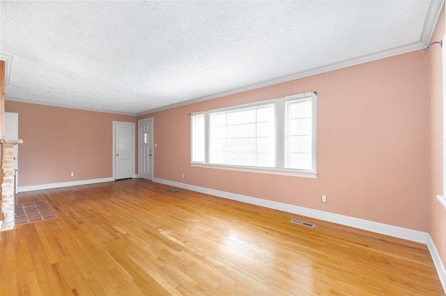 unfurnished living room with ornamental molding, wood-type flooring, and a textured ceiling