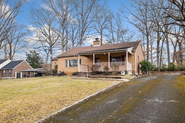 bungalow-style home with covered porch and a front lawn