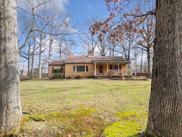 ranch-style house featuring a porch and a front lawn