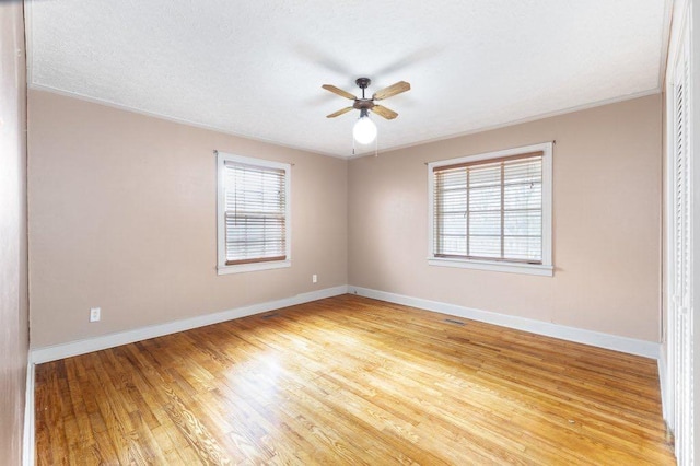 spare room featuring ceiling fan and light wood-type flooring