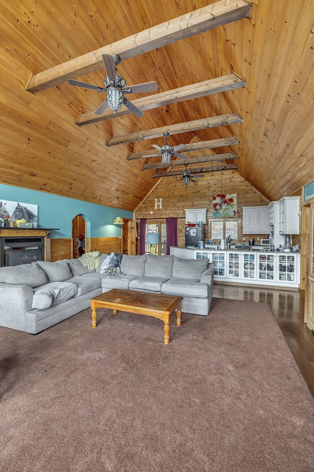 living room with high vaulted ceiling, carpet floors, ceiling fan, wooden ceiling, and beam ceiling