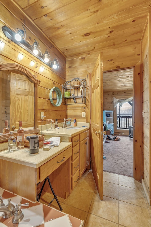 bathroom featuring tile patterned flooring, vanity, wooden ceiling, and wood walls