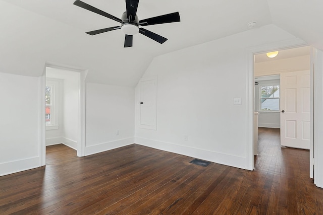 unfurnished room with dark wood-type flooring, ceiling fan, and vaulted ceiling