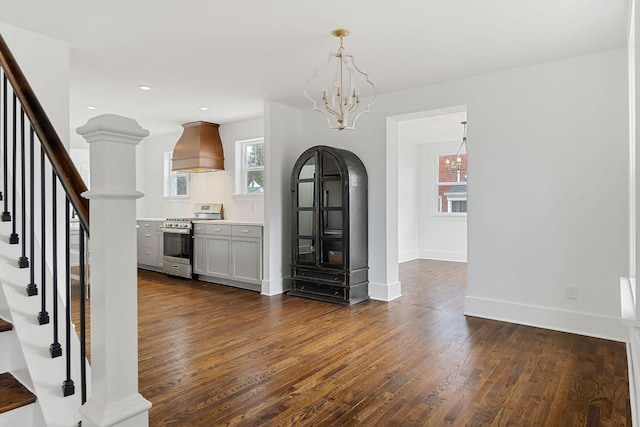 interior space featuring dark hardwood / wood-style floors and an inviting chandelier