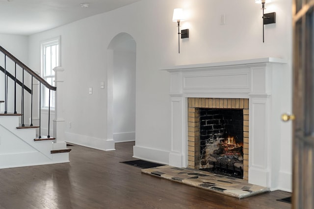 unfurnished living room with a fireplace and dark hardwood / wood-style floors