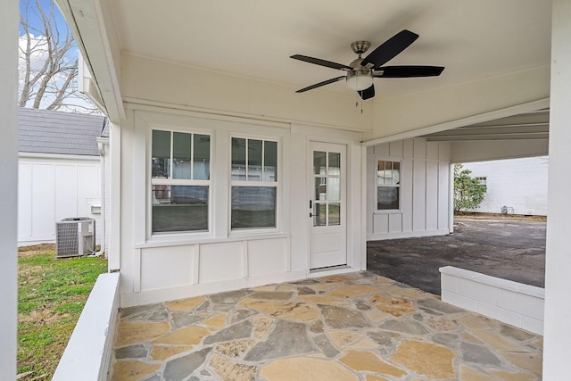 entrance to property with ceiling fan, central AC unit, and a patio area