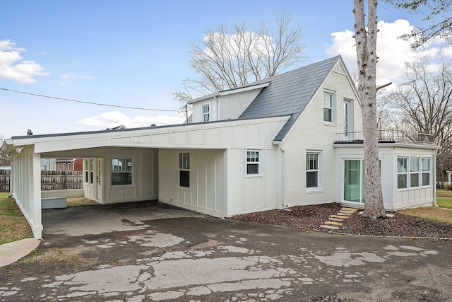 back of property featuring a carport