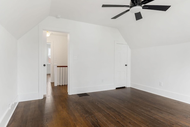 additional living space with ceiling fan, dark hardwood / wood-style floors, and vaulted ceiling