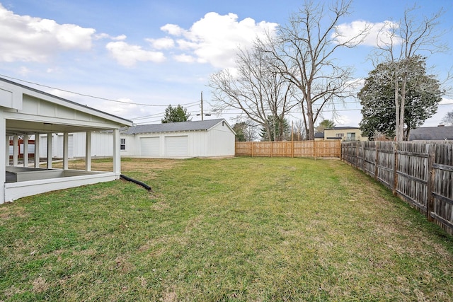 view of yard featuring an outbuilding and a garage