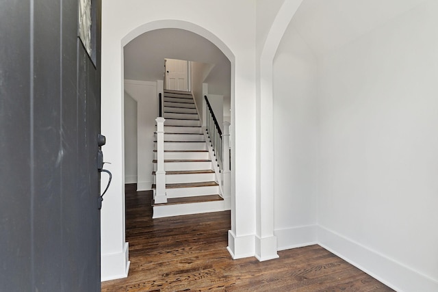 staircase featuring wood-type flooring