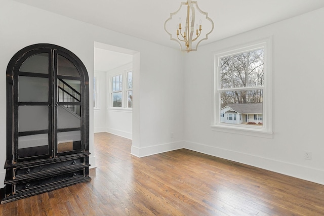 interior space featuring hardwood / wood-style flooring and a chandelier