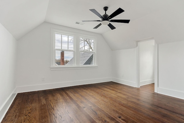 additional living space featuring lofted ceiling, dark hardwood / wood-style floors, and ceiling fan