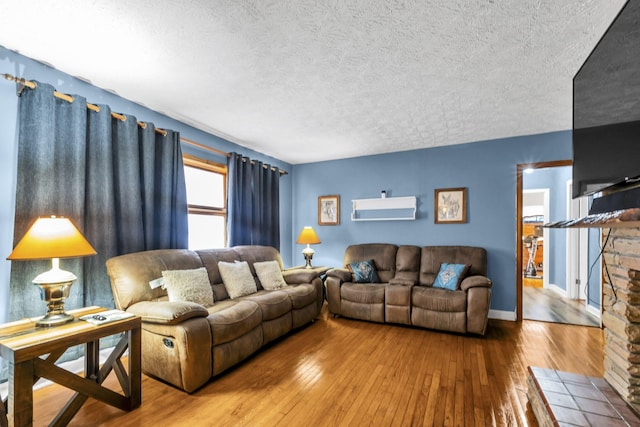 living room with hardwood / wood-style floors and a textured ceiling