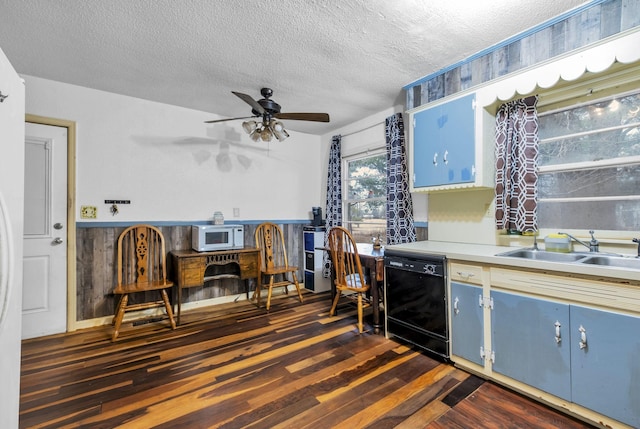 kitchen with sink, blue cabinetry, black dishwasher, a textured ceiling, and dark hardwood / wood-style flooring