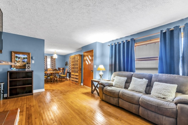 living room with hardwood / wood-style flooring and a textured ceiling