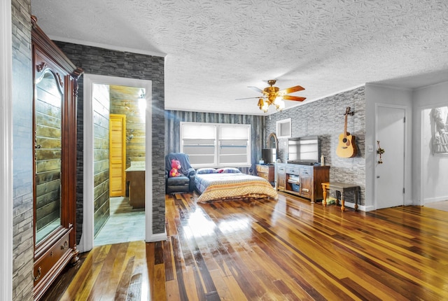 unfurnished bedroom with ceiling fan, hardwood / wood-style flooring, and a textured ceiling