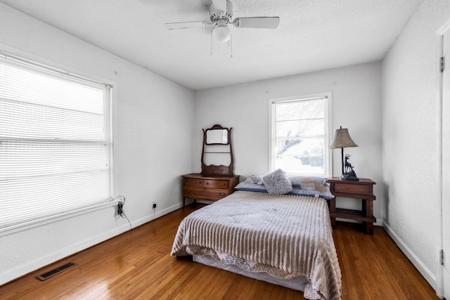 bedroom featuring hardwood / wood-style flooring and ceiling fan