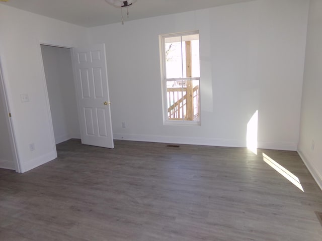 empty room featuring dark wood-type flooring