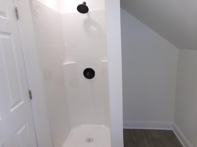 bathroom featuring a tile shower and hardwood / wood-style flooring