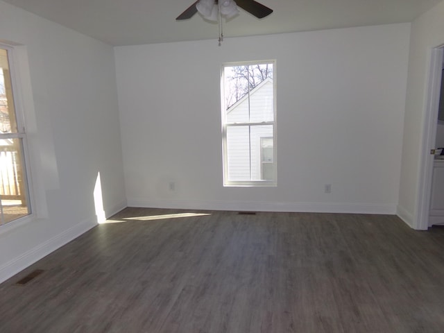 unfurnished room with dark hardwood / wood-style floors and ceiling fan