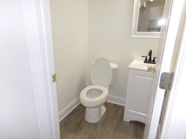 bathroom featuring vanity, hardwood / wood-style floors, and toilet