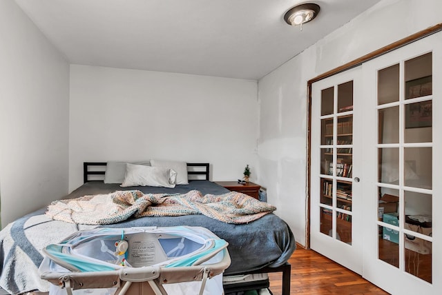 bedroom with wood-type flooring and french doors