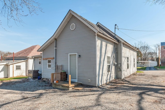 rear view of house featuring cooling unit