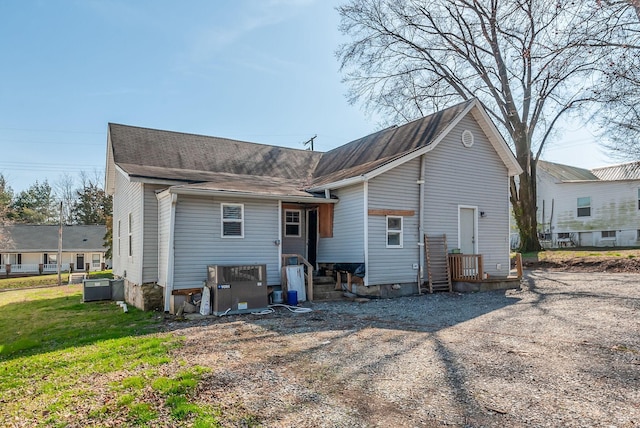 rear view of house featuring a yard