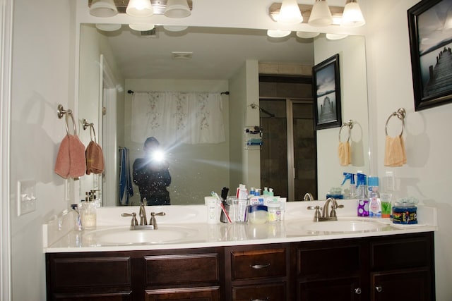 bathroom featuring walk in shower and vanity