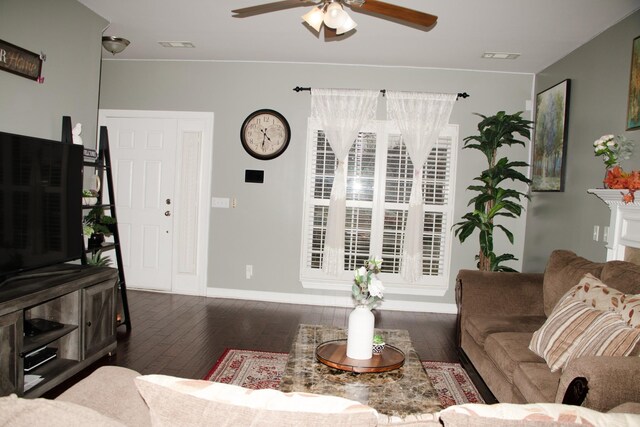 living room with dark wood-type flooring and ceiling fan