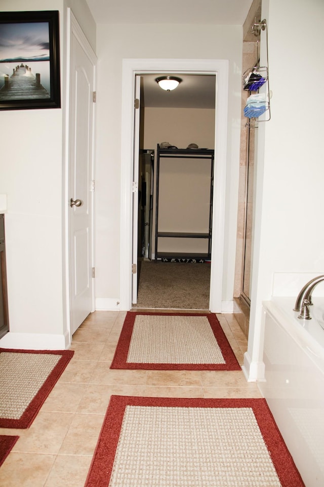 hallway featuring light tile patterned floors