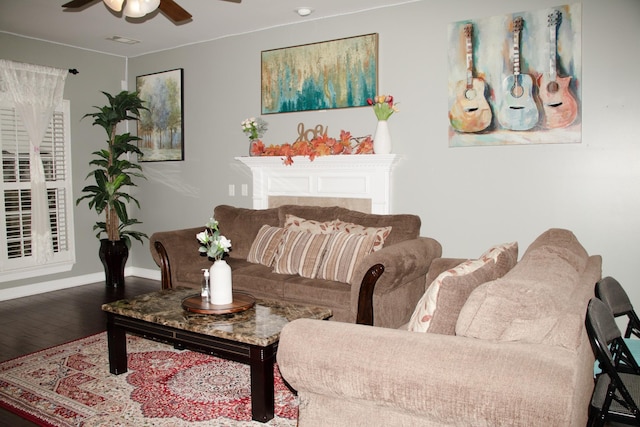 living room with wood-type flooring and ceiling fan