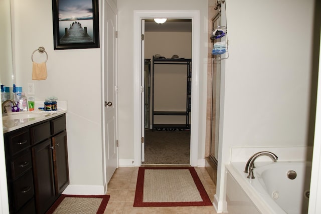 bathroom featuring vanity, tile patterned flooring, and separate shower and tub