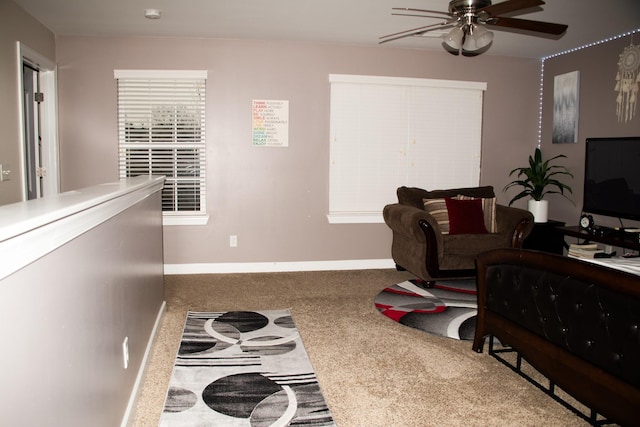 living room with ceiling fan and carpet floors