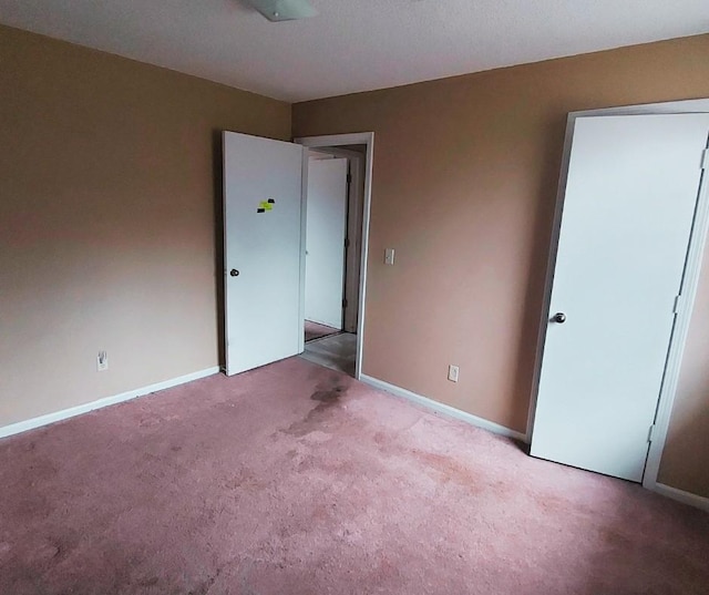 unfurnished bedroom featuring light colored carpet