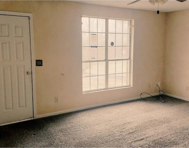 spare room featuring carpet, a healthy amount of sunlight, and ceiling fan