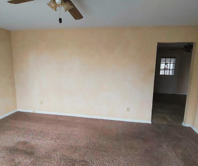 carpeted spare room with ceiling fan