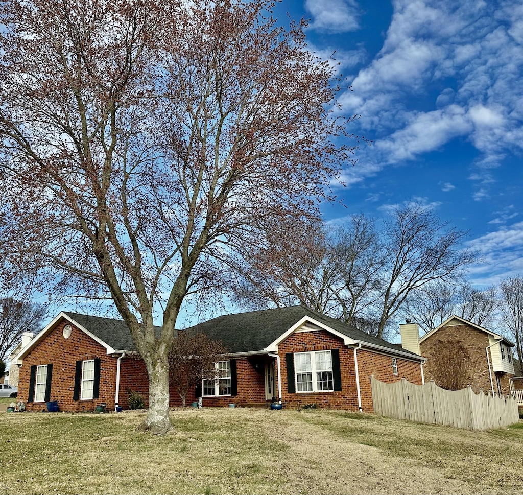 ranch-style house with a front lawn