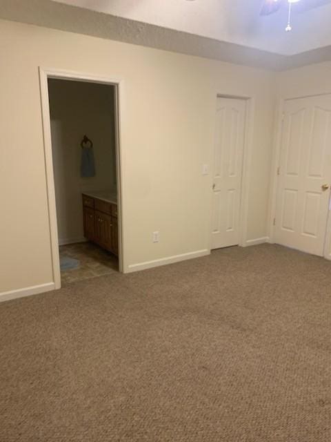 spare room with carpet floors and ceiling fan