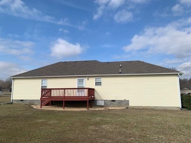 back of property with a wooden deck and a yard