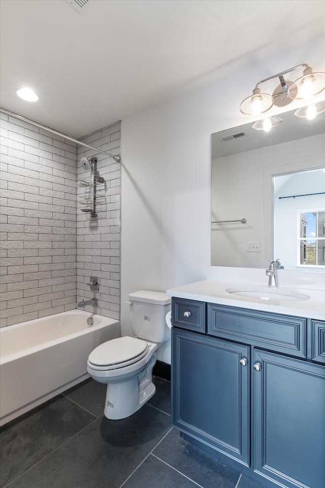 full bathroom with tile patterned flooring, vanity, tiled shower / bath combo, and toilet