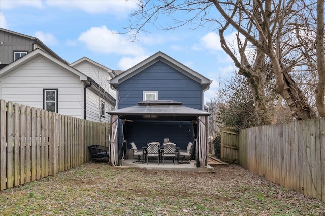 back of property with a gazebo and a patio area