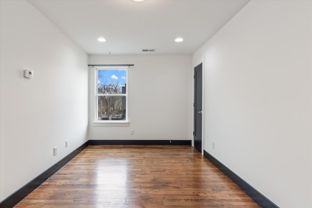 spare room featuring dark hardwood / wood-style floors