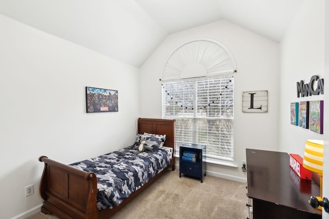 bedroom with lofted ceiling and light colored carpet