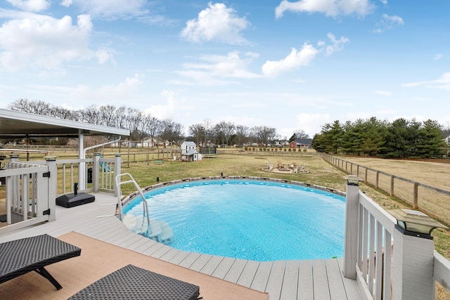 view of pool with a yard and a deck