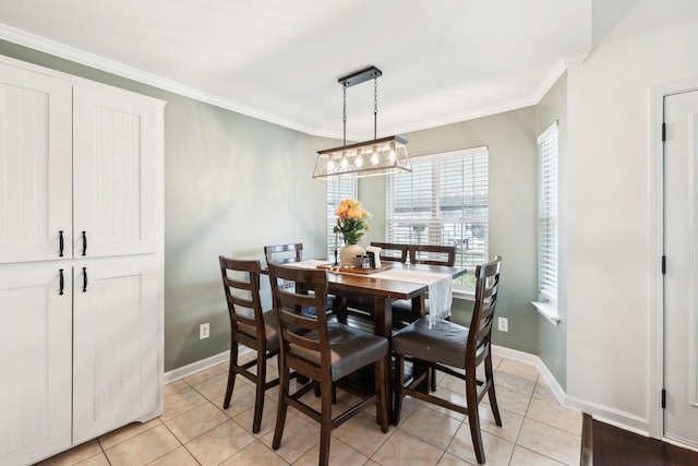 dining room featuring crown molding and light tile patterned flooring