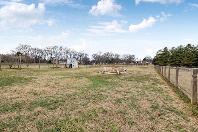 view of yard with a rural view and a fire pit